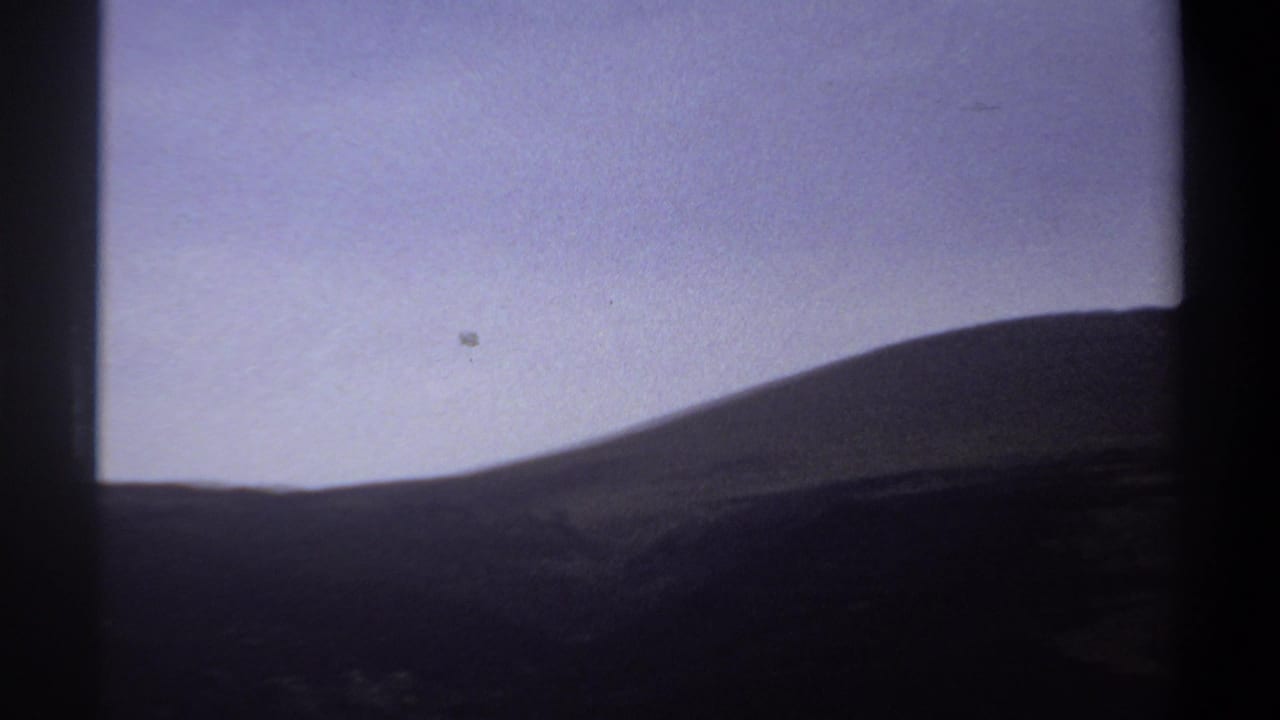 1969 Khartoum landscape frame with a rounded hill, hazy sky, and dark vertical border from the film scan.