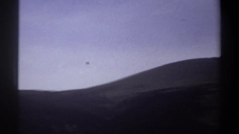 1969 Khartoum landscape frame with a rounded hill, hazy sky, and dark vertical border from the film scan.