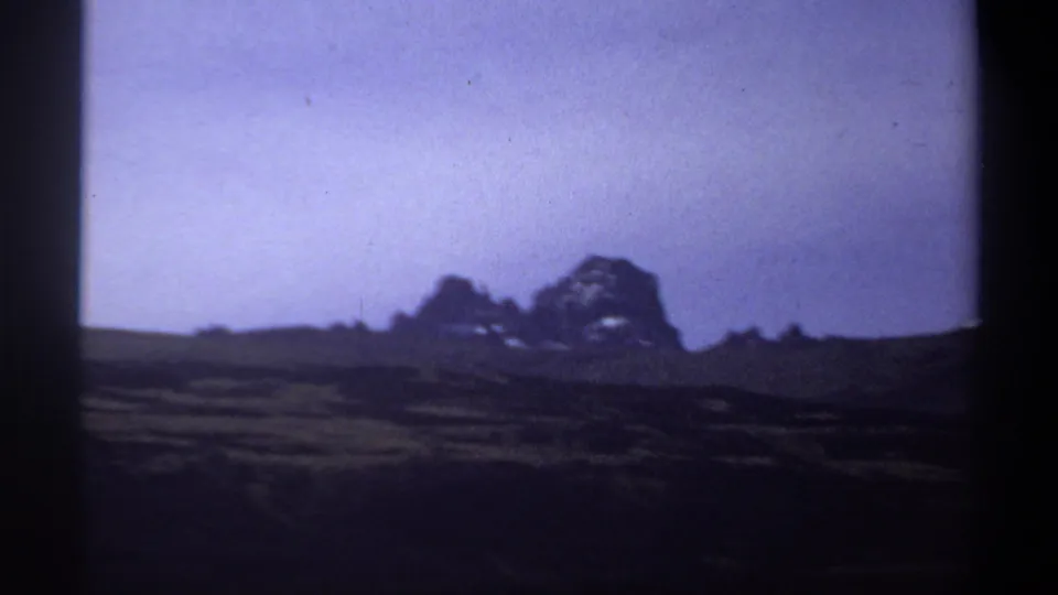 Home-movie view of rolling grassland and distant mountain silhouettes in the Sudan-labeled 1969 clip.
