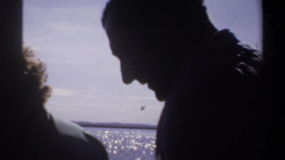 Silhouetted figures on a boat in Khartoum, Sudan, appear against sunlit water in 1969 home-movie footage.