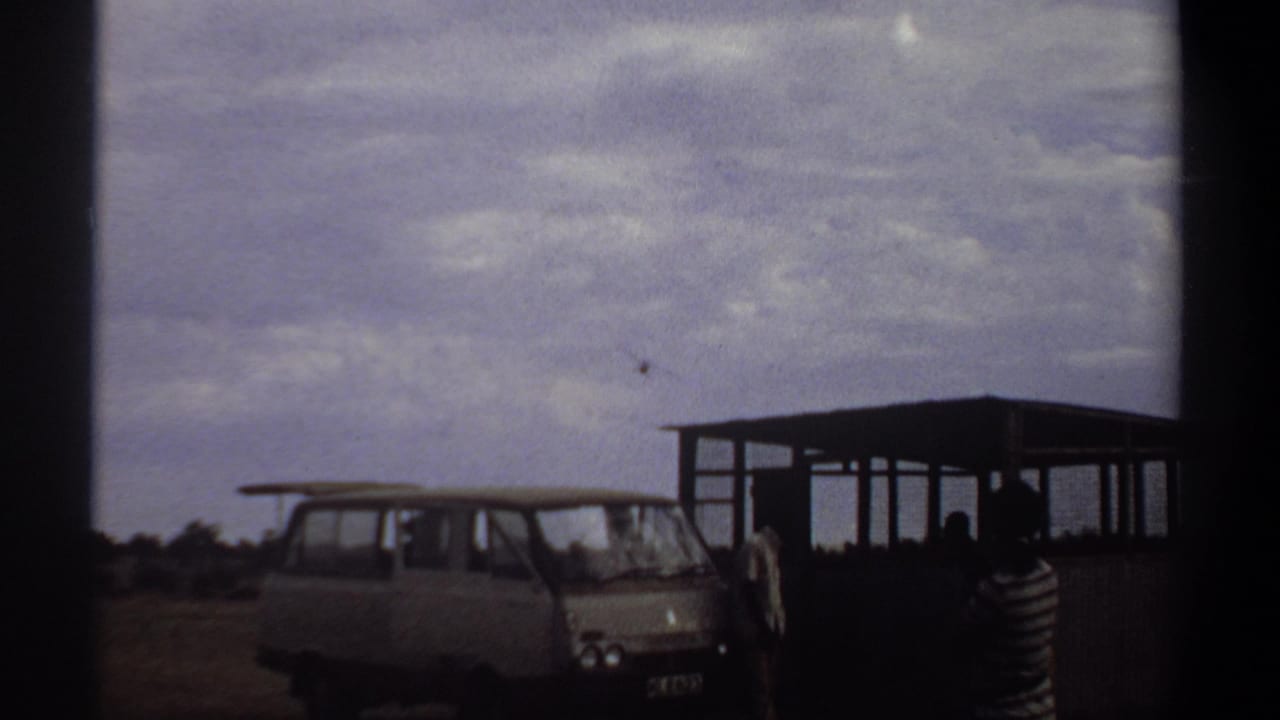 1969 Khartoum footage shows the aircraft higher in the sky while onlookers remain beside the van and open shelter.