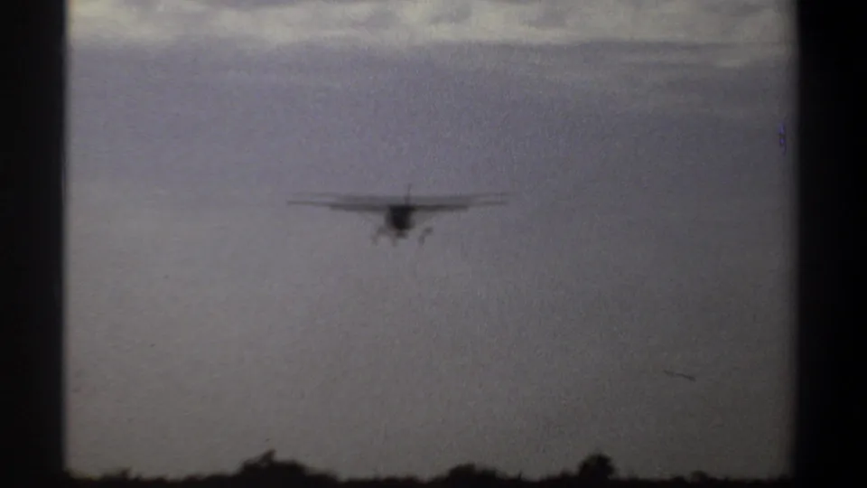 Small single-engine airplane descending toward a runway near Khartoum, Sudan, in 1969 home-movie footage.