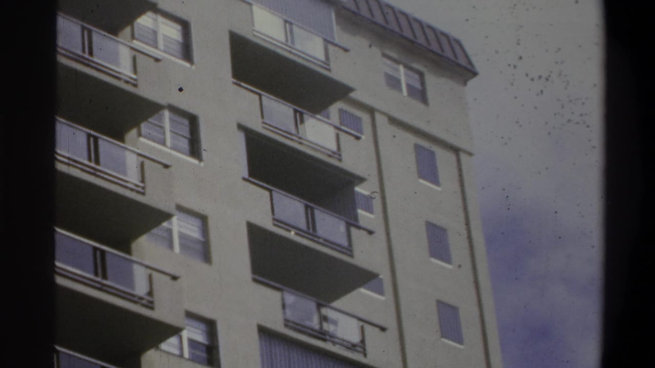 8mm home movie close-up of a light-colored multi-story building with horizontal balconies, likely a US coastal resort or hotel, circa 1973.