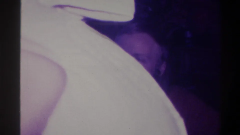 Camera pan or movement frame, circa 1973; overexposed light-toned shape fills most of frame with partial figure at lower right edge.