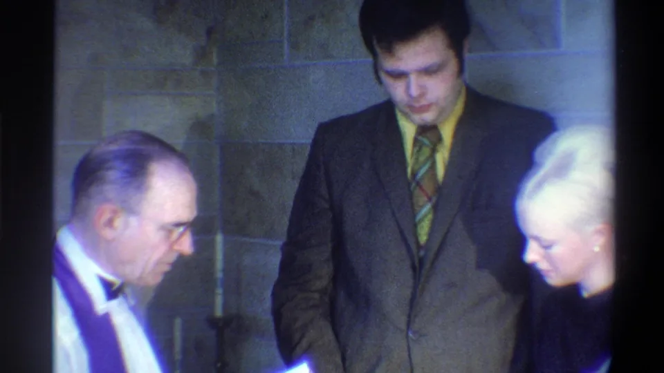 Bride turns slightly revealing her profile beside the officiant; 8mm home movie footage, Gainesville, Florida, 1974.