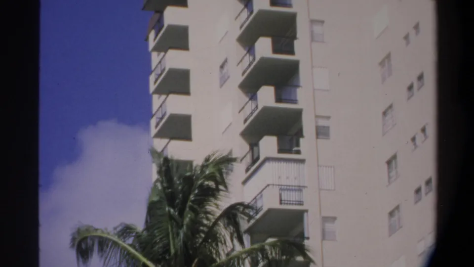 Final Super 8 frame of the Gainesville, Florida apartment building showing balconies and palm fronds, consistent with 1974 home movie footage.