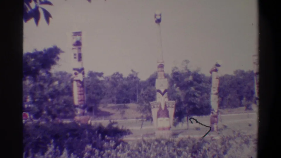 Multiple painted decorative totem-style columns in a park setting, Gainesville Florida area, 1974, shot on 8mm home movie film