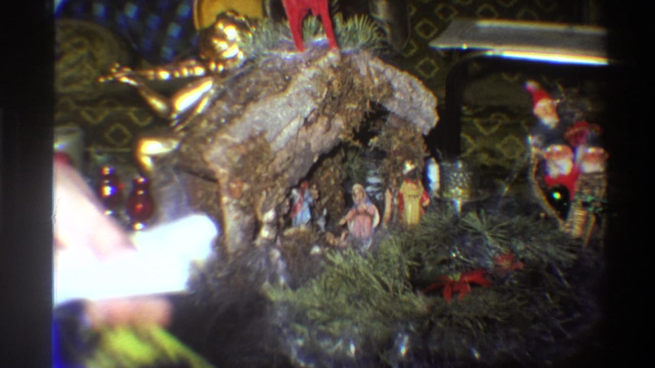 8mm home-movie frame of a nativity crèche interrupted by a light flare, a common artefact of amateur mid-1970s filming.