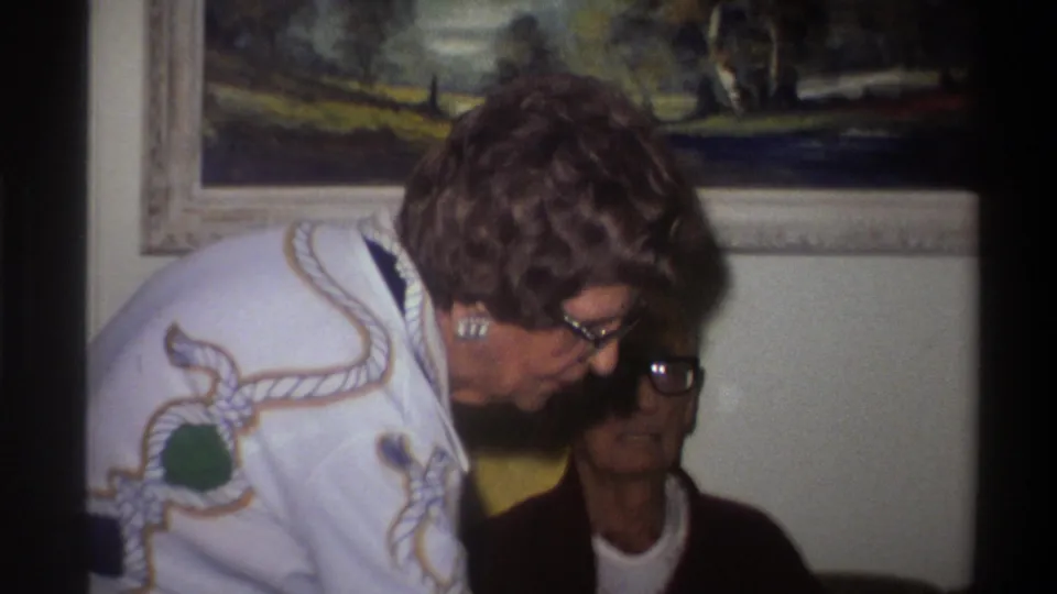 Closer 8mm frame from a 1975 Gainesville Florida home movie; both women's faces and period clothing are more legible in this tighter composition.