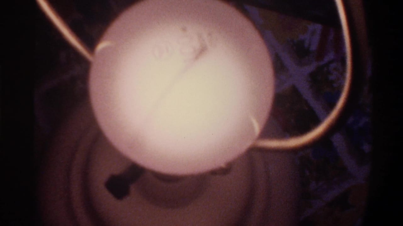 Globe Christmas lights with a partial star ornament at right edge; 8mm home movie, Gainesville Florida, circa 1975.