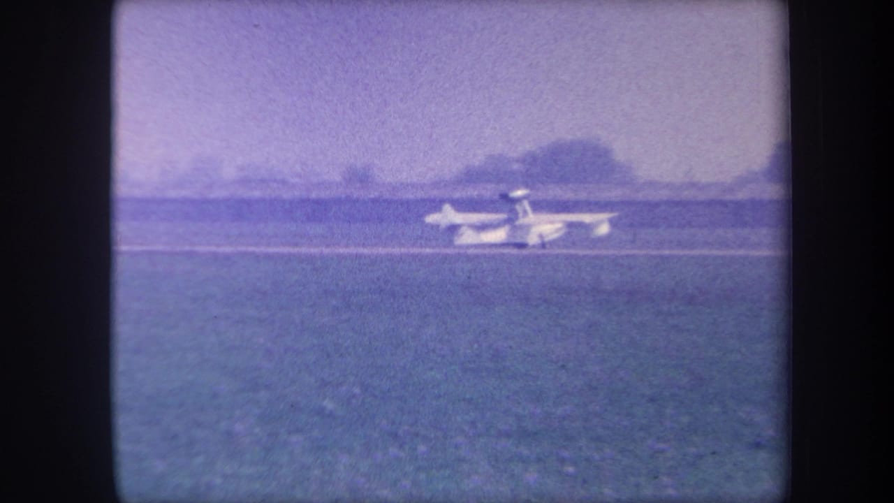 Light single-engine aircraft rolling on a rural grass airstrip, possibly Yucaipa, California, circa 1959, filmed on 8mm color reversal stock.