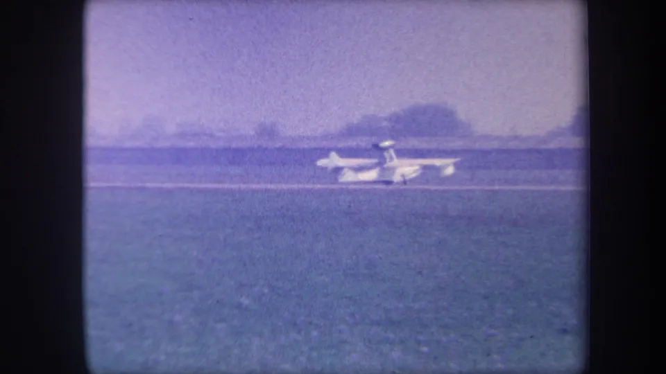 Light single-engine aircraft rolling on a rural grass airstrip, possibly Yucaipa, California, circa 1959, filmed on 8mm color reversal stock.