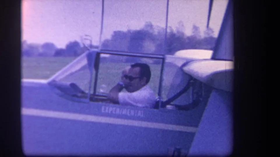 1959 Yucaipa frame of the pilot turning inside the experimental glider cockpit, filmed close beside the fuselage.