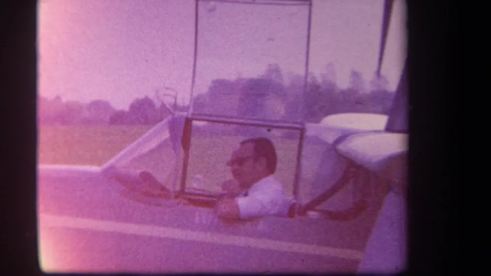 In 1959 Yucaipa-area home-movie footage, a man in a white shirt sits inside the cockpit of a small amphibious aircraft.