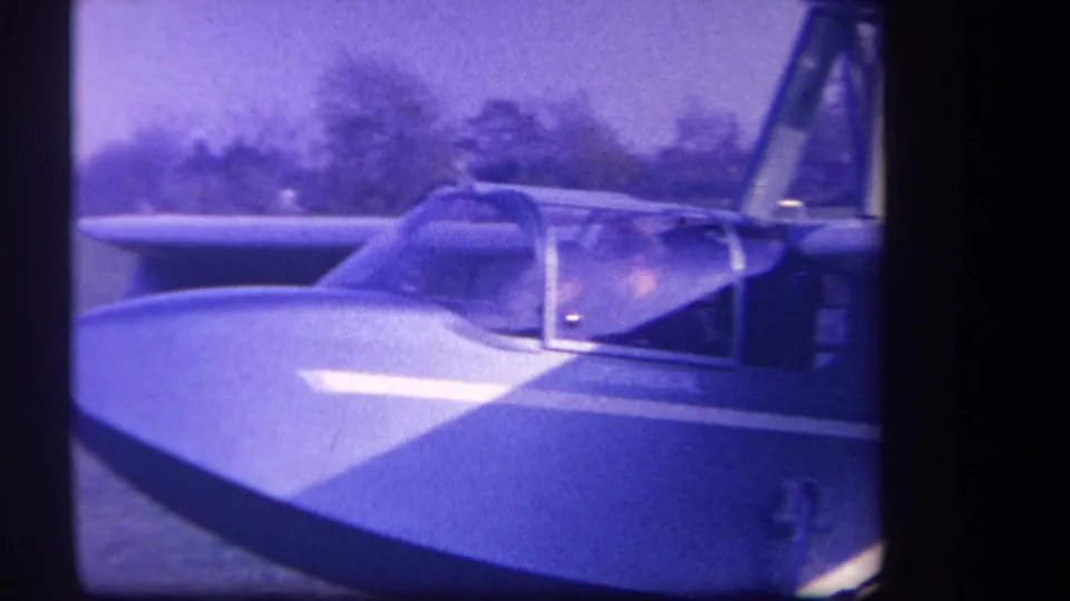 Small experimental aircraft at Volmer Yucaipa in 1959, with two cockpit occupants partly visible through the canopy.