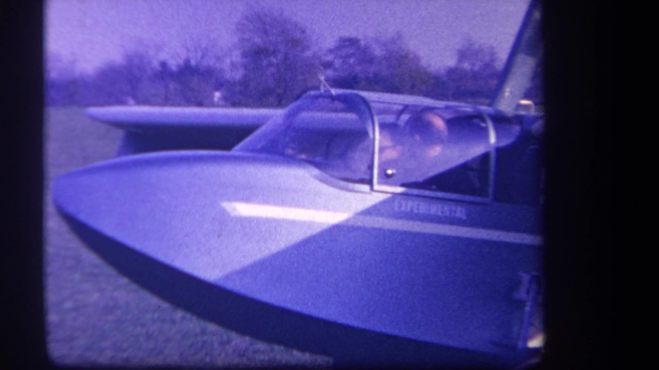 Side view of the aircraft cockpit and nose with EXPERIMENTAL lettering partly visible.