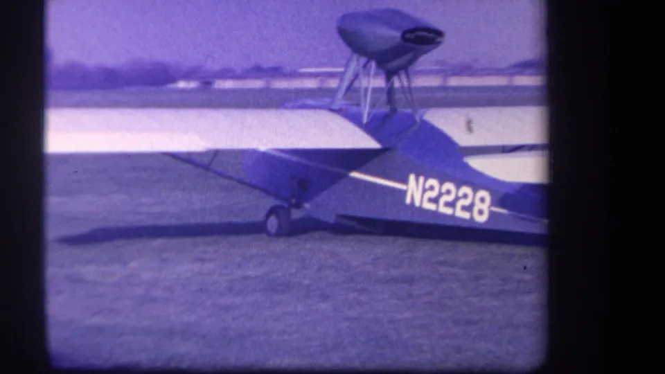 1959 Yucaipa-area 8mm frame showing the small aircraft in side view, with registration N2228 visible on the fuselage.