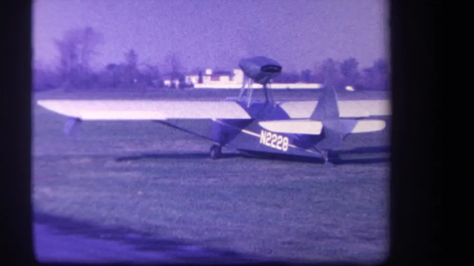 Side view of the small aircraft on a grassy airfield in the supplied 1959 Yucaipa, California clip.