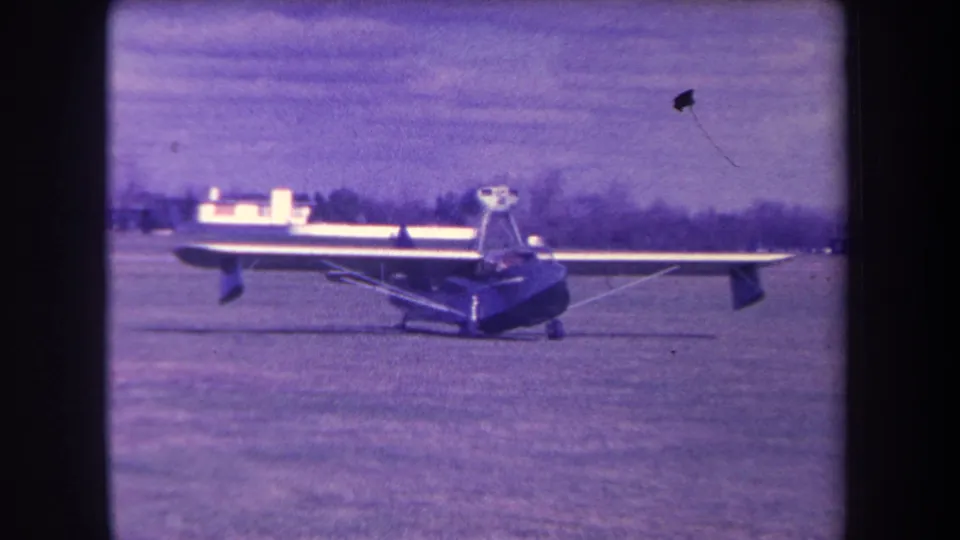 1963 home-movie frame showing the light aircraft from the side on a grassy Yucaipa-area airfield.