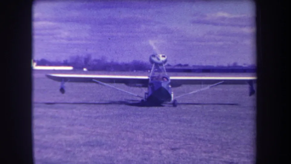 1963 Yucaipa frame with the small propeller aircraft still facing camera, faint haze near the engine area, and a pilot area visible.
