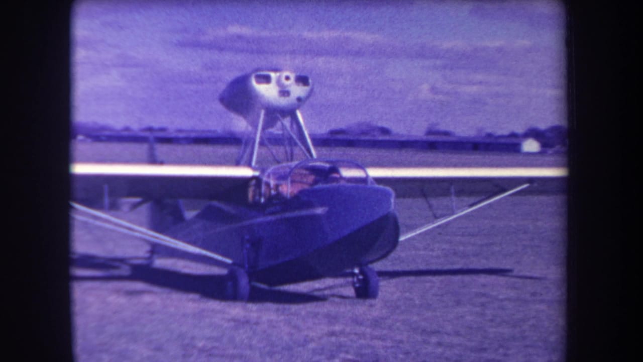 1963 California airfield frame showing the amphibious aircraft closer to camera with people visible in the cockpit.