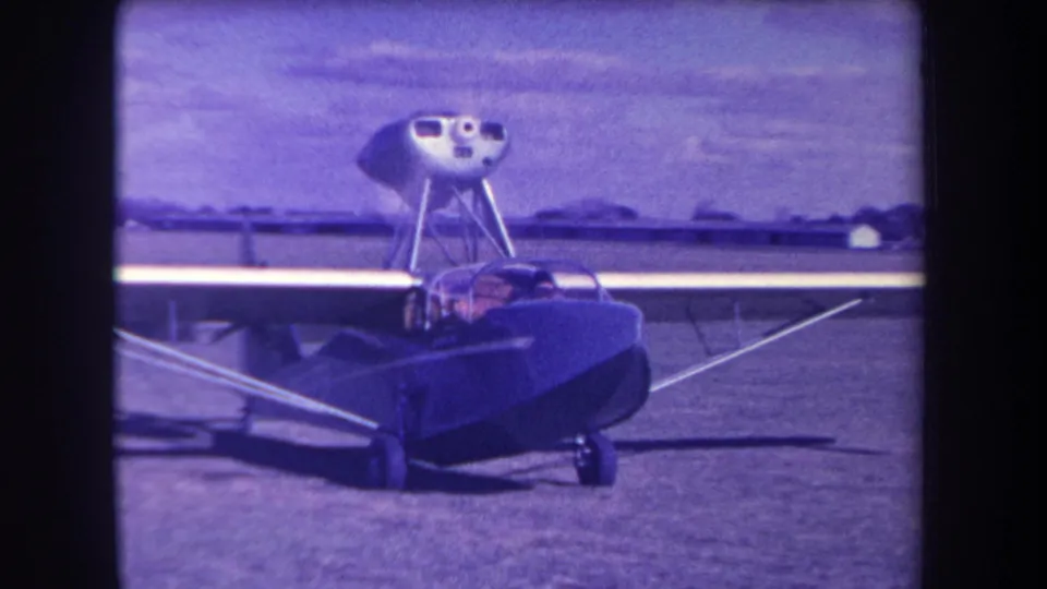 1963 California airfield frame showing the amphibious aircraft closer to camera with people visible in the cockpit.
