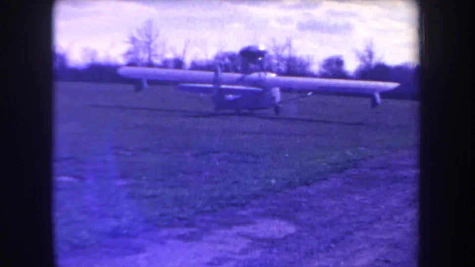 Wide 1963 Yucaipa view of a small autogyro or light aircraft taxiing across grass with trees and sky in the background.