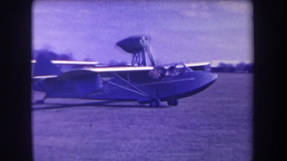 Final frame shows the amphibious aircraft continuing across the Yucaipa grass airfield with aged purple 8mm color shift.