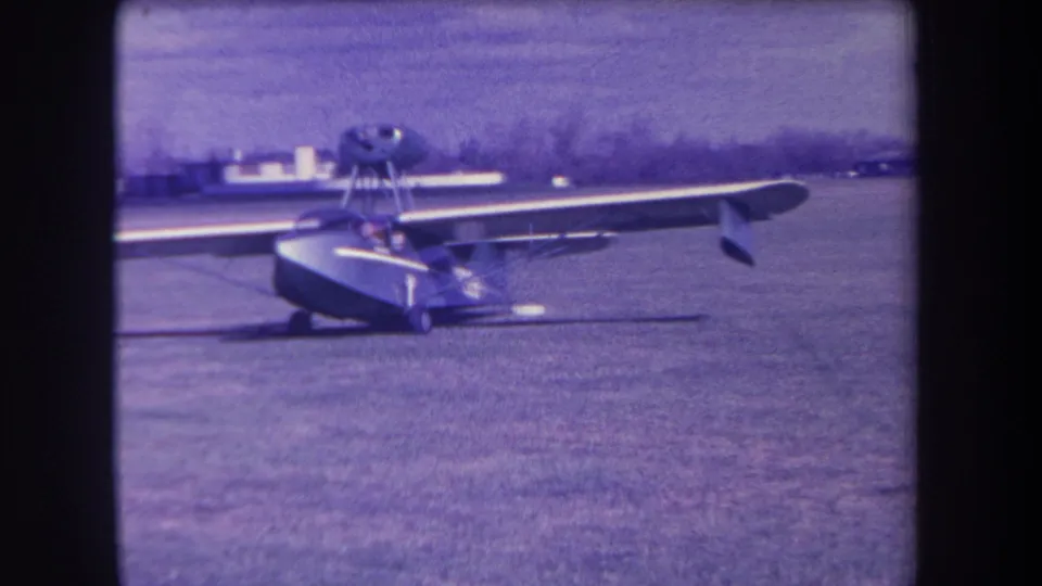 Front-quarter 1963 home-movie view of the Volmer Yucaipa amphibious aircraft on a California grass airfield.