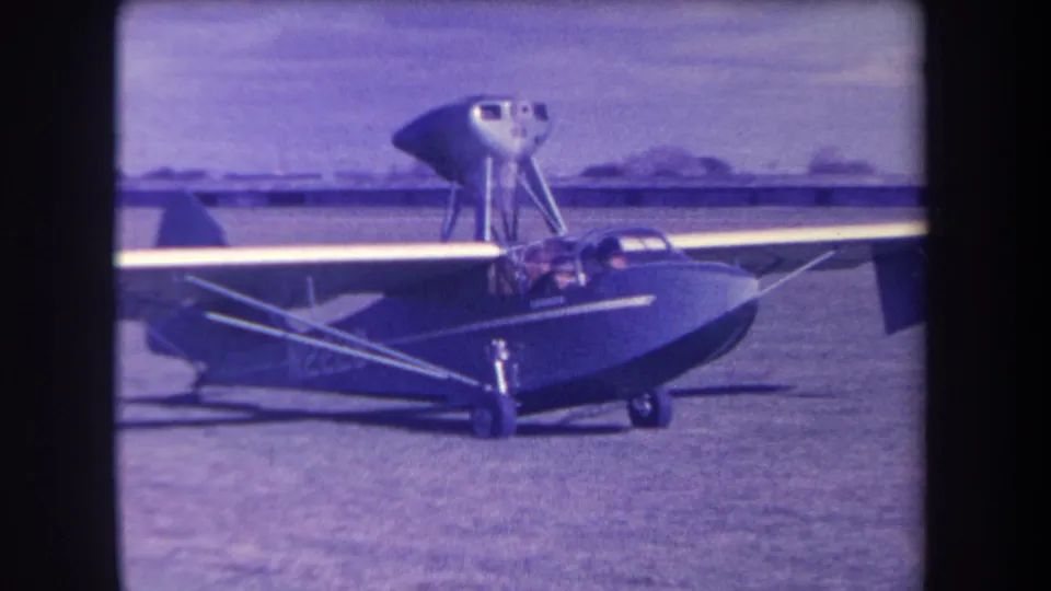 Closer 1963 view of the amphibious aircraft at Yucaipa, with its high wing, cockpit, and grass-field setting visible.