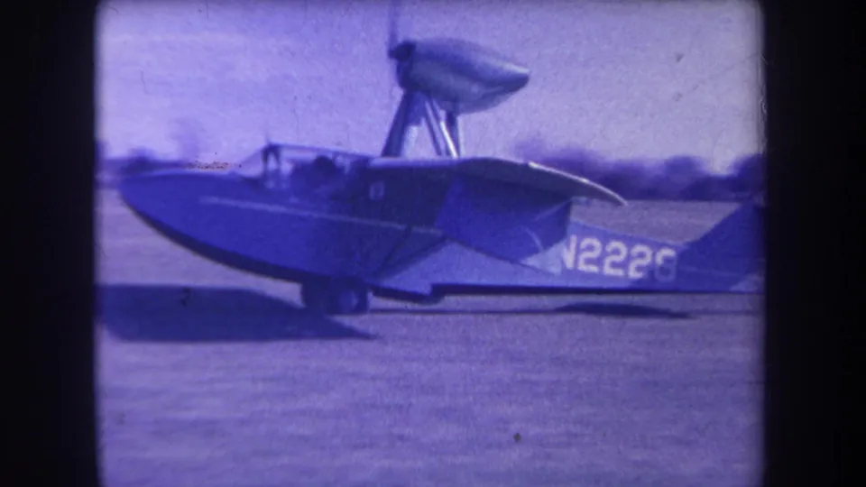 The blue-and-white amphibious plane marked N2226 is filmed from the side on the Yucaipa airfield in 1963.