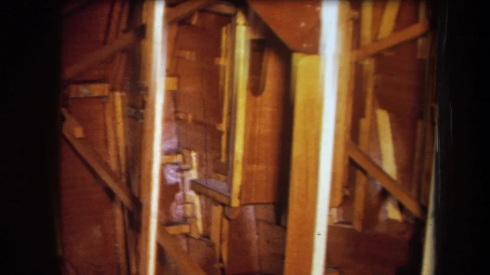 Final 1964 Yucaipa frame showing exposed wooden studs and braces inside an unfinished building interior.