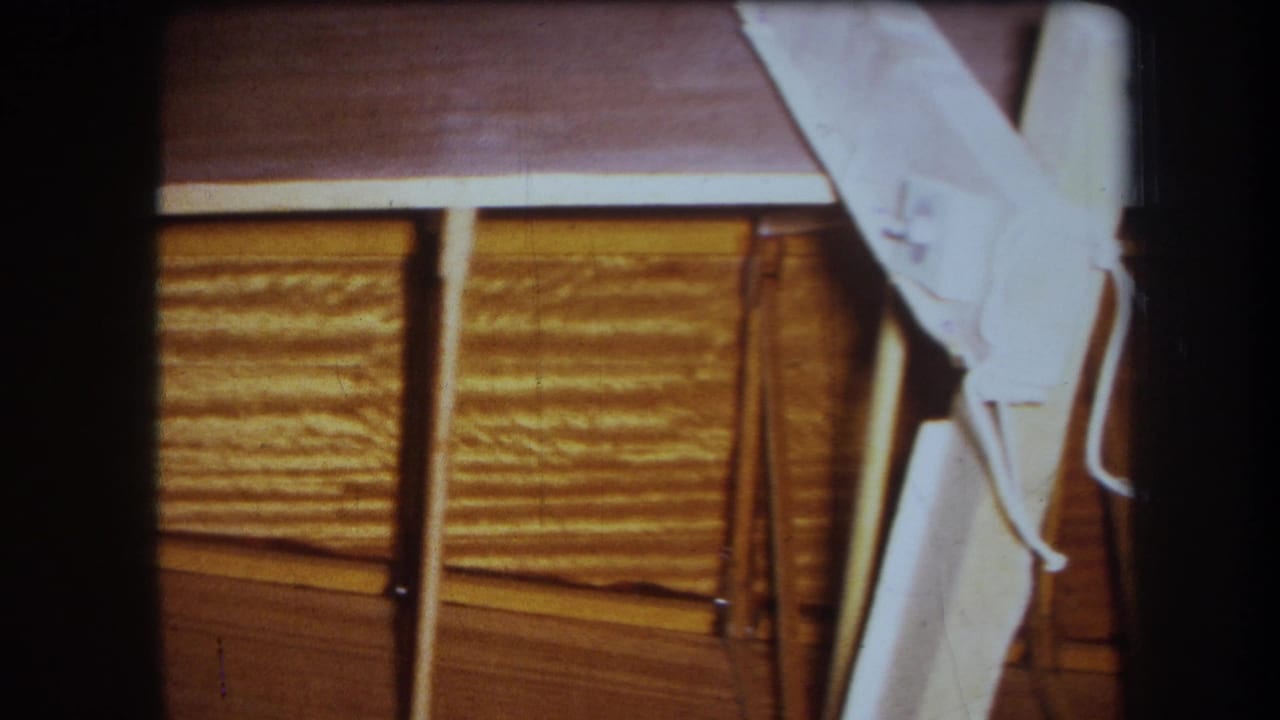 Wood ceiling framing with a white-painted brace entering along the right edge.