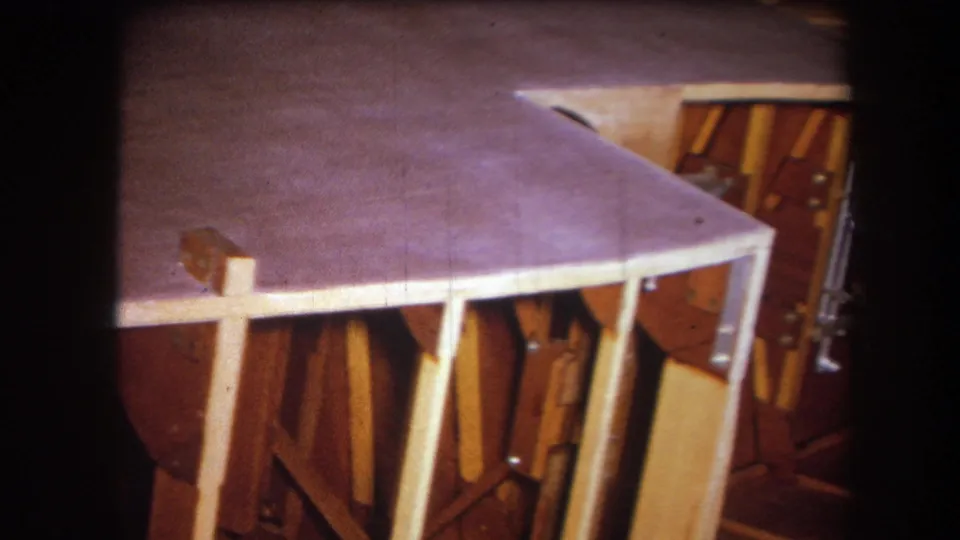 1964 8mm frame in Yucaipa showing a closer angled view of the purple surface, pale support pieces, and exposed wood underside.