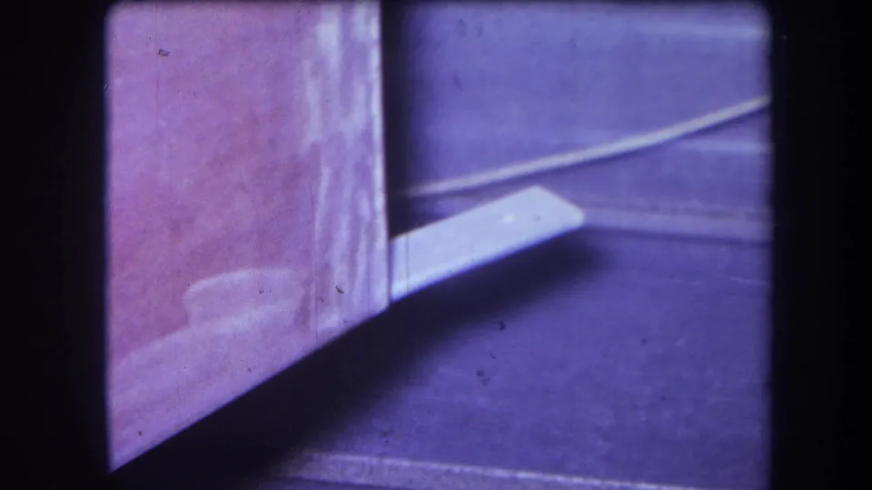 Final 1964 Yucaipa frame shows the purple side of the structure beside a floor area crossed by a white strip or cable-like line.