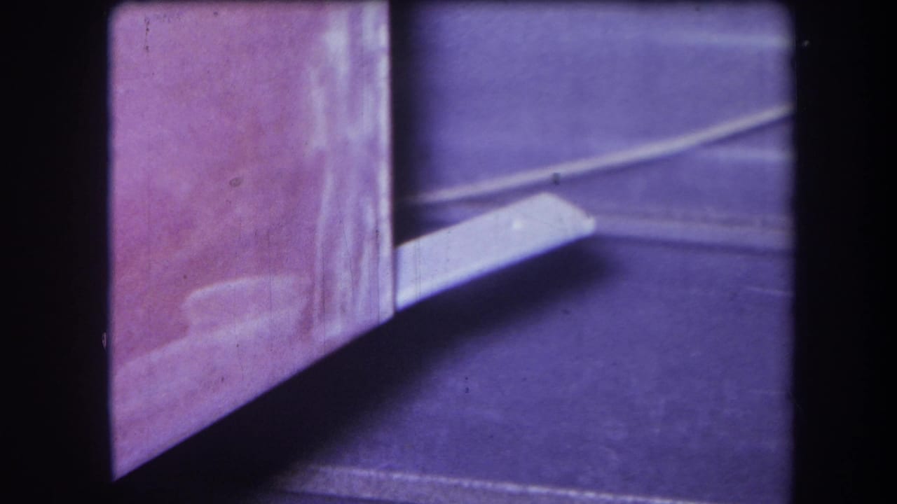 White protruding object beside a pink corner surface and dark blue-purple floor.
