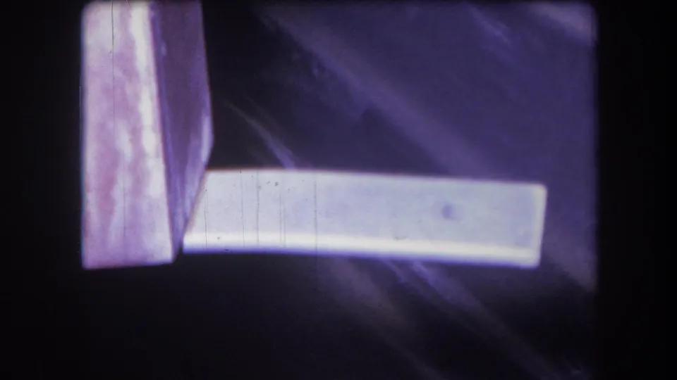 Final 1964 Yucaipa frame showing the white object below a vertical pink-purple edge, with soft focus and visible 8mm film wear.