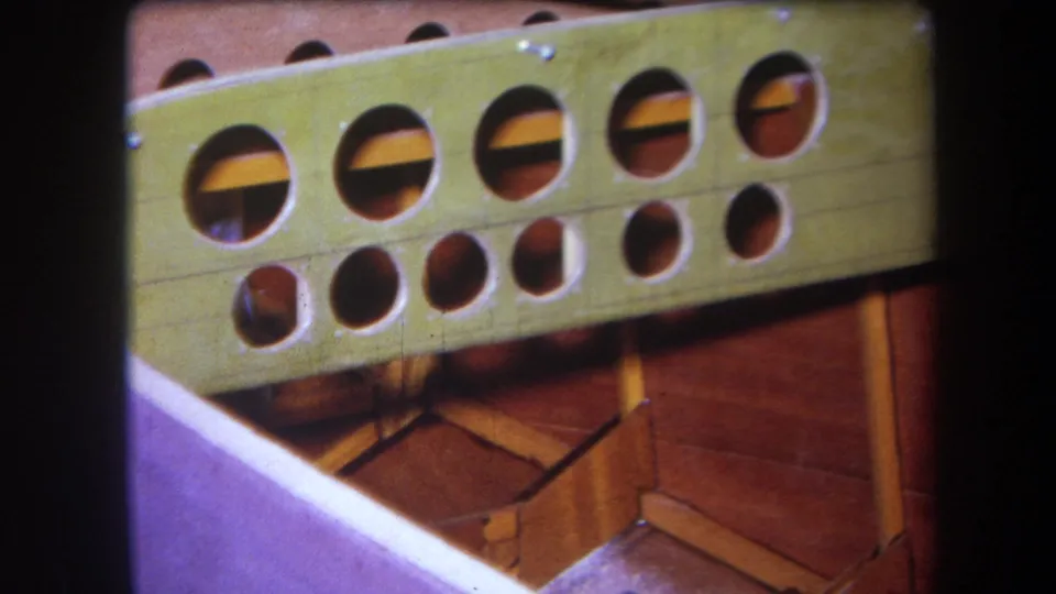 1964 8mm frame from Yucaipa showing the drilled green boat frame and varnished internal wooden structure.