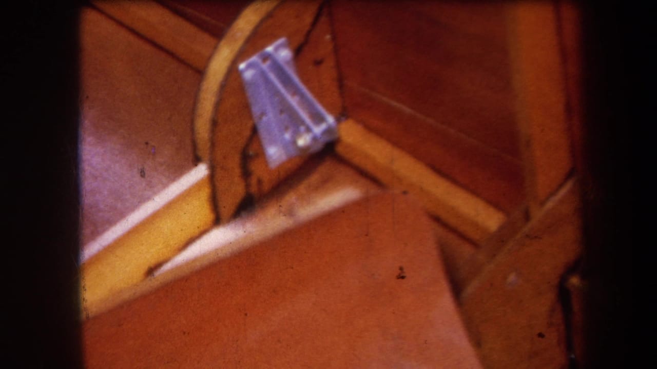 Similar close-up of the wooden structure with a metal bracket near a yellow rail.