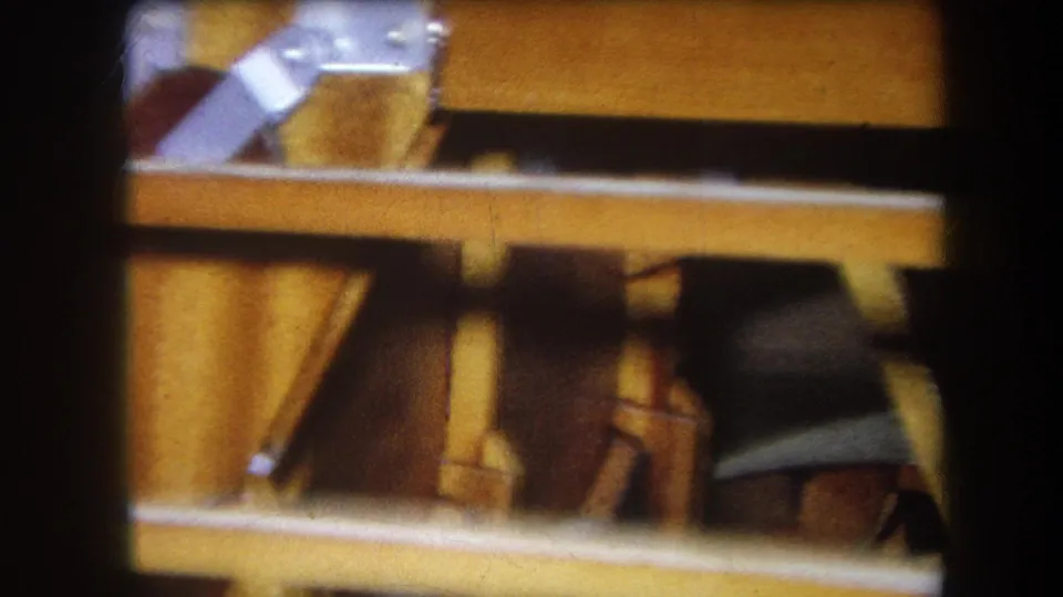 1964 Yucaipa close-up showing lower wooden supports, a horizontal rail, and darker interior shapes as the camera pans across.