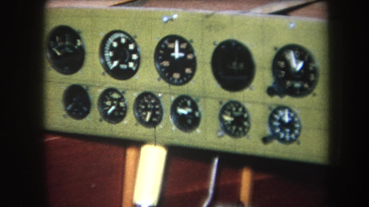 1964 Yucaipa-area home-movie frame showing a green painted wooden instrument panel with multiple black analog gauges.