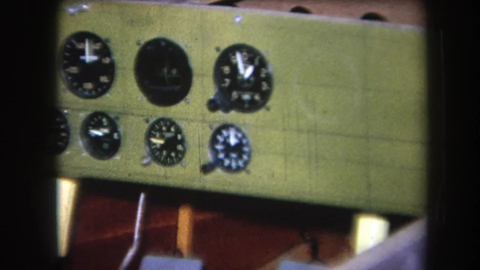 1964 Yucaipa-area home-movie frame showing a green wooden instrument panel with black gauges and visible wood construction beneath.