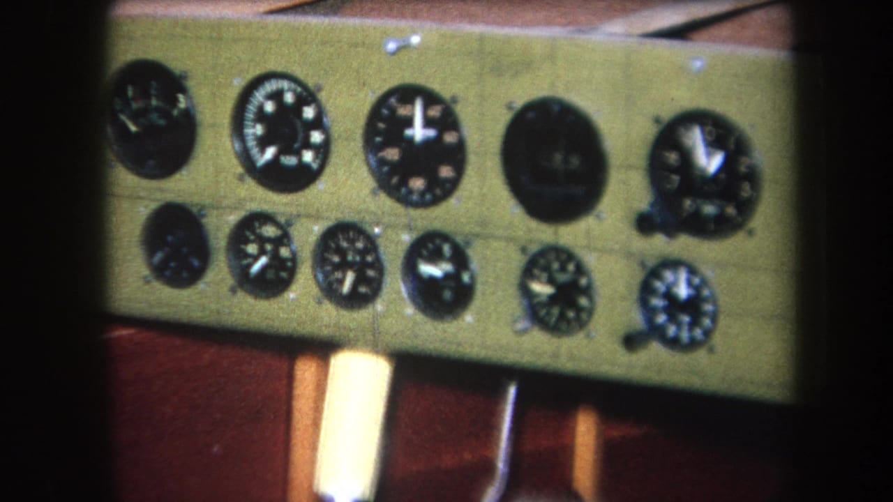Instrument cluster with multiple circular dials on a green dashboard panel.