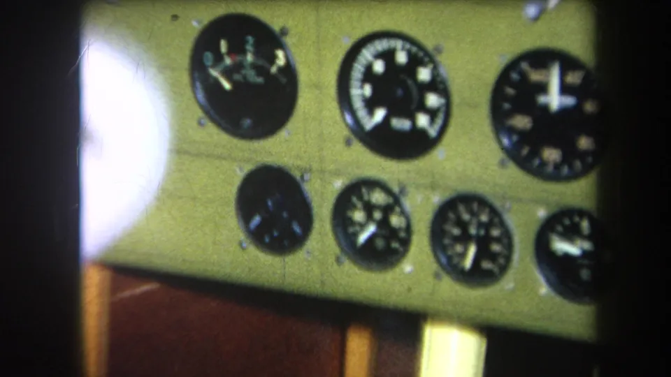 1964 8mm frame from Yucaipa-area footage showing several round analog gauges on a pale green mechanical panel.