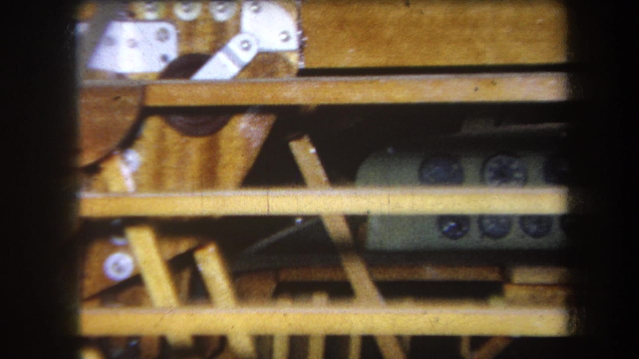 Close view of yellow gauges below wood framing and metal brackets.