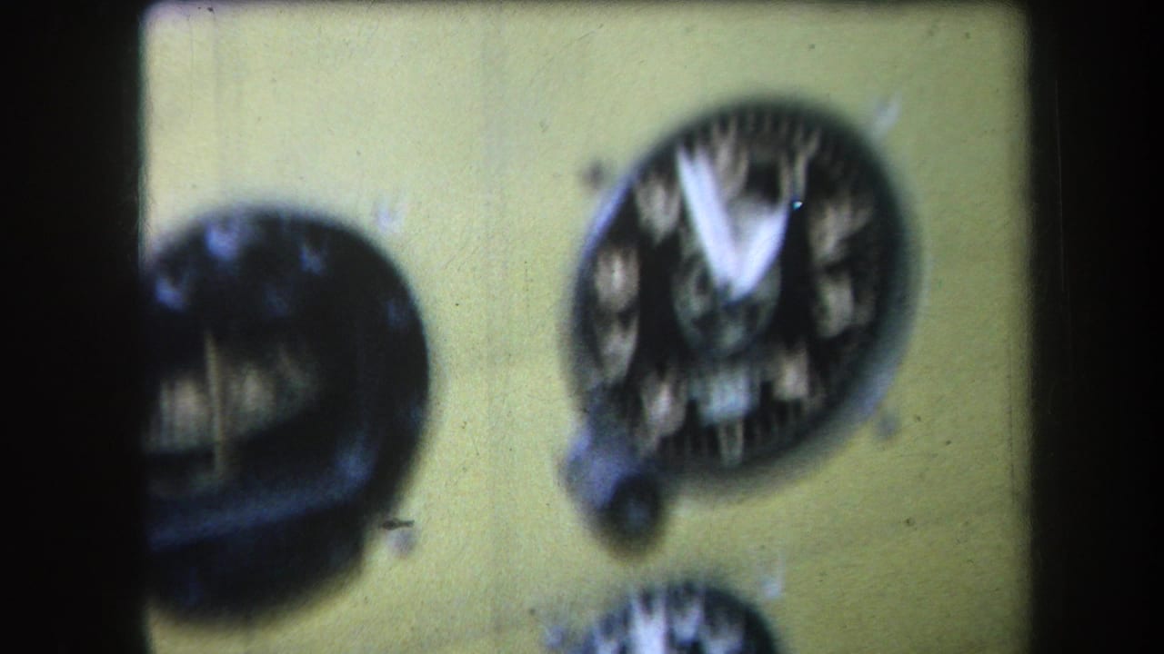 Yellow cockpit instrument panel with two cropped black analog gauges.