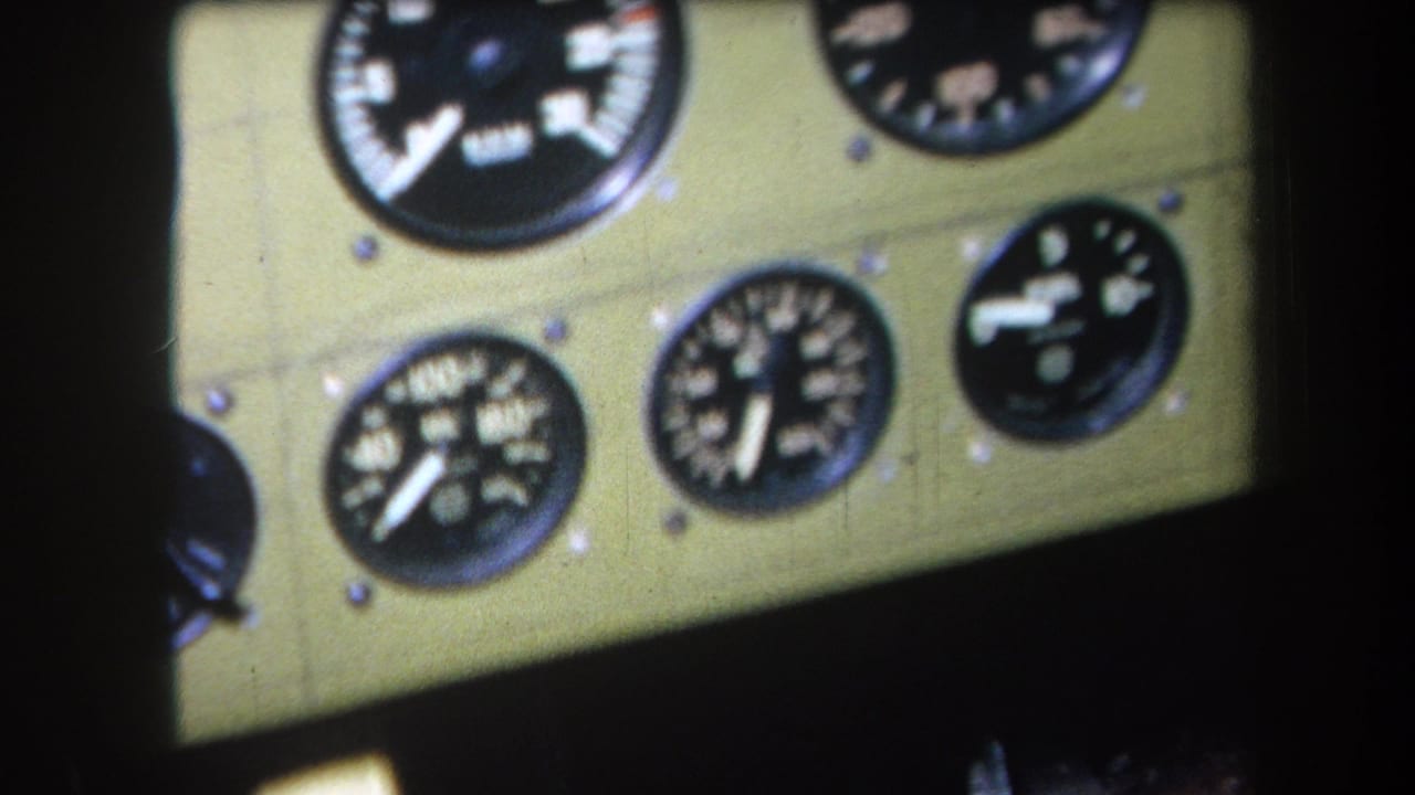 Analog flight gauges on a green panel, partly cropped by dark cockpit framing.