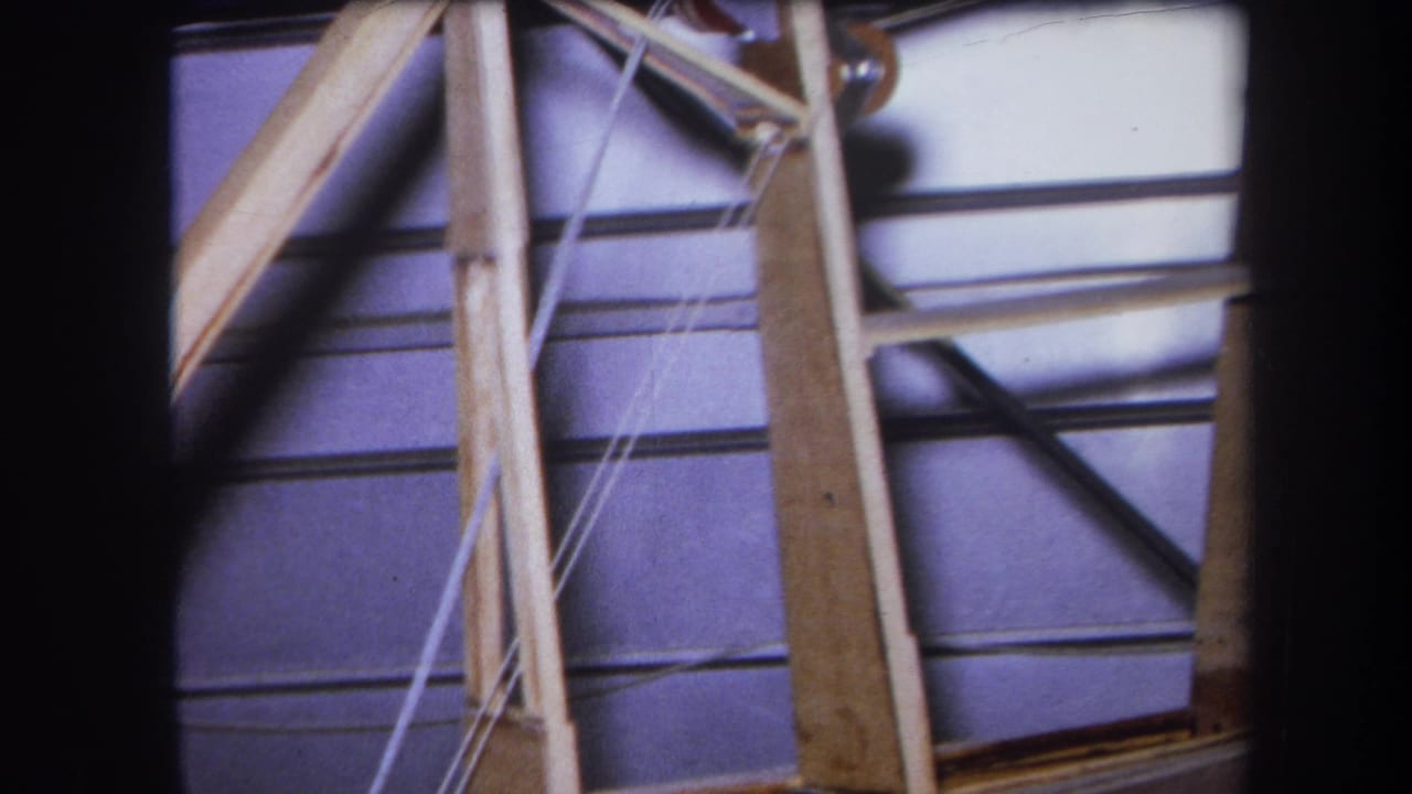 Pulley hardware and wooden framing against paneled interior walls.