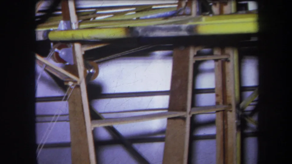 1964 Yucaipa frame showing a yellow-painted beam above pulley hardware, wood framing, cables, and metal rods.