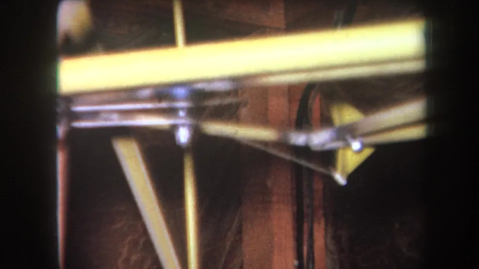 1964 Yucaipa close-up of painted reinforcement hardware and exposed wooden structure with handheld 8mm softness.